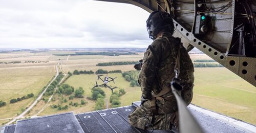 A small UAS is launched from the back of a CH-47 Chinook helicopter during Exercise 'Hornets String' on 31 July 2025.