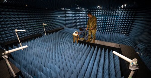 Personnel from the Australian Joint PNT Directorate and the US Joint Navigation Warfare Center align GPS test equipment in an anechoic chamber at Kirtland Air Force Base in New Mexico in preparation for a GPS resilience test in April 2024.