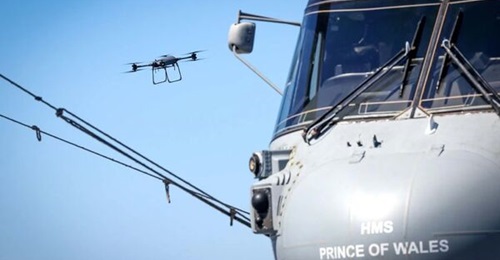 A Malloy T-150 drone seen operating between the HMS
        
         aircraft carrier and HMS 
        
         destroyer during the CSG25 deployment, marking the first RN ship-to-ship cargo delivery using a UAV.