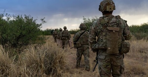 US soldiers with the 2nd Stryker Brigade Combat Team, 4th Infantry Division, conduct a patrol near Bisbee, Arizona, in June 2025.