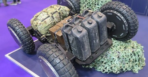 The AZAK S26 wheel on a small four-wheel UGV displayed at DSEI 2025.