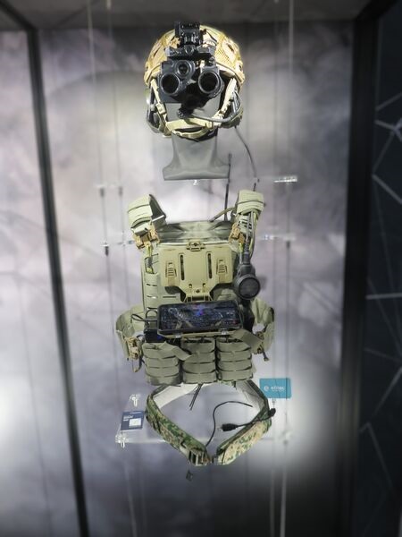 Rheinmetall's Gladius soldier system - with night-vision goggles, showing the smartphone end-user device and, at the bottom, Elitac's haptic navigation belt - displayed at DSEI 2025.