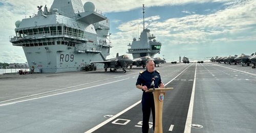 Commodore James Blackmore, commander of CSG25, is seen here on the flight deck of HMS 
        
         while it was in Singapore for its second stop in the country for 2025.