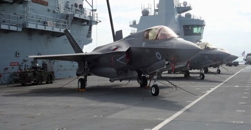 An F-35B fighter aircraft on the flight deck of HMS 
        
         at Changi Naval Base.
