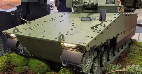 A model of HSW's Ratel heavy IFV concept fitted with ZSSW-30 RWS, showcased at MSPO 2025.