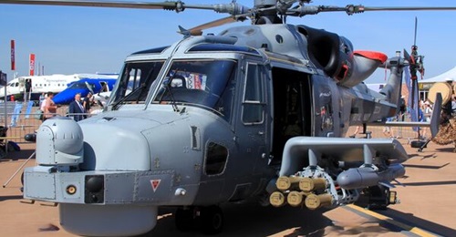 A Royal Navy Leonardo AW159 Wildcat fitted with weapons wings that are shown carrying Martlet missiles on their inboard stations.
