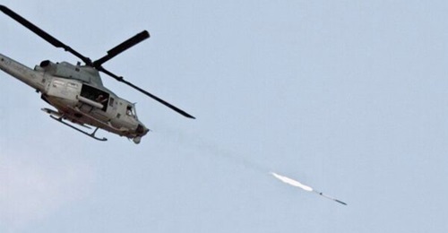 A UH-1 helicopter fires a 2.75 inch Advanced Precision Kill Weapon System (APKWS) rocket.