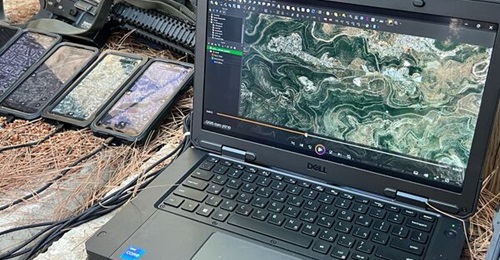 A Taurus workstation with handheld Orion devices plugged in for updating.