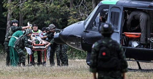 An injured person is taken to a military helicopter during clashes along the Thai-Cambodia border in Thailand's Surin province on 10 December.