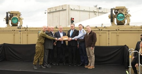 Israeli officials stand in front of an Iron Beam (Or Eitan) laser weapon during the system's official handover to the IDF at Rafael's headquarters.