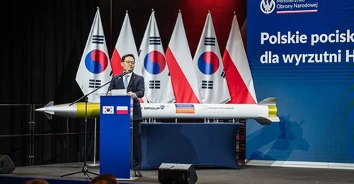 A CGR-080 guided rocket seen behind CEO and president of Hanwha Aerospace, Jae-il Son, at the signing of a Polish rocket production contract in Kielce, Poland, on 29 December 2025.