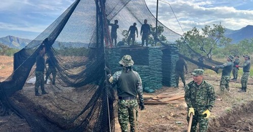 Colombian soldiers erect a counter-unmanned aircraft systems net.