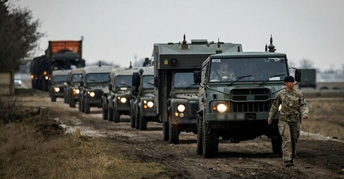 A convoy of British Army vehicles including a Pinzgauer and Land Rovers seen in Romania during NATO Exercise 'Steadfast Dart' in February 2025.