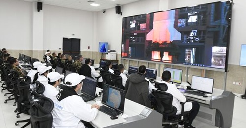 Algerian and Chinese personnel watch a Long March 2C rocket launch AlSat-3A.
