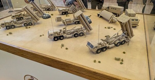 A 1:30 scale model of a THAAD battery (with a model Patriot launcher in the centre), displayed by the Qatar Emiri Air Defence Forces at DIMDEX 2026.