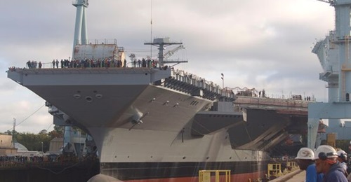 Aircraft carrier 
        
        , shown here under construction in dry-dock, got underway for sea trials.