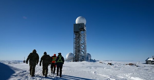 US Air Force personnel walk up to North Warning System Site CAM-5A, Cape McLoughlin, Northwest Territories, Canada, in April 2025.
