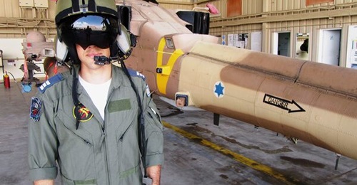An IAF pilot poses in front of his AH-64D Apache attack helicopter. The US has now approved the sale of the latest AH-64E to Israel, along with additional AW119Kx training helicopters.