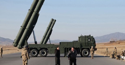 North Korean leader Kim Jong-un stands in front of the MRL system test-fired by the country's Missile Administration in January.