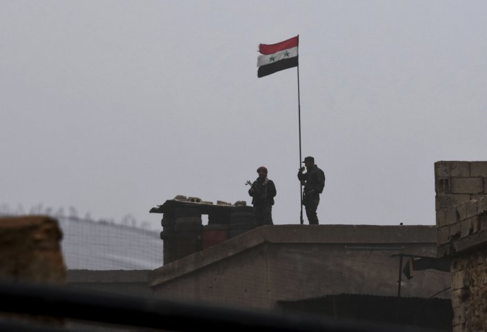 Syrian government troops are seen at a position south of Manbij on 30 December. (AFP/Getty Images)