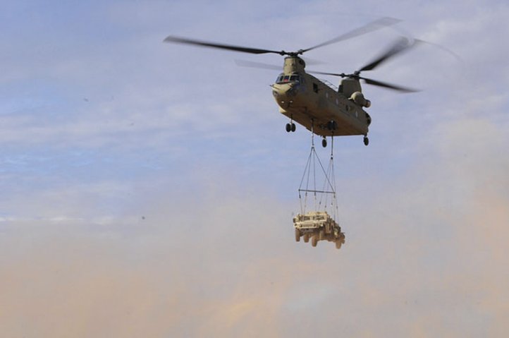 A CH-47 Chinook transports a Humvee during a sling load operation in July 2017. The US Army Reserve is set to acquire 60 JLTVs to train on in preparation for phasing out the Humvee. (US Army)