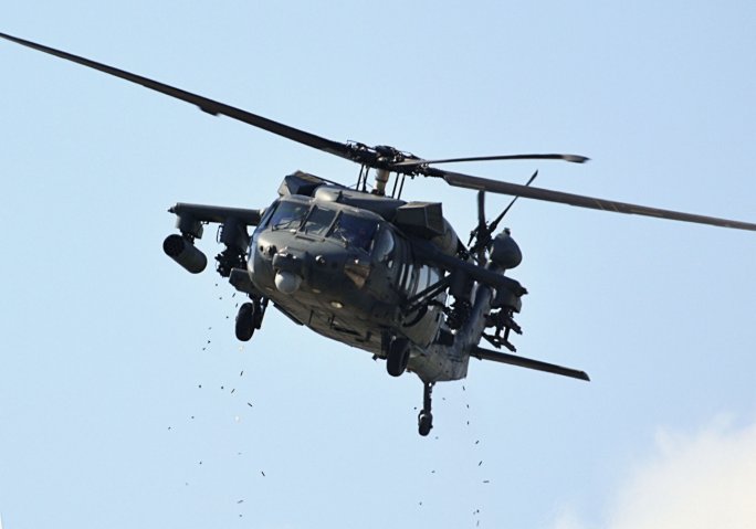 A weaponised UAE Joint Aviation Command UH-60M fires its GAU-19 miniguns during the IDEX 2019 dynamic display. (Patrick Allen/IHS Markit)