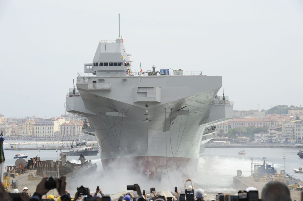 
        The LHD
        Trieste
        during its launch. Note the limited space between the shipyard and Castellammare port’s pier: just 450 m for a 214 m hull length, which required specific arrangements to increase hull friction in the water.
       (Luca Peruzzi)