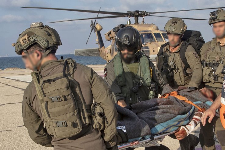 Israeli soldiers unload what appeared to be a casualty at Ramban hospital in Haifa after a Hizbullah missile attack on the Lebanese border. The IDF subsequently announced the attack caused no casualties. (Gil Nehushtan/AFP/Getty Images)