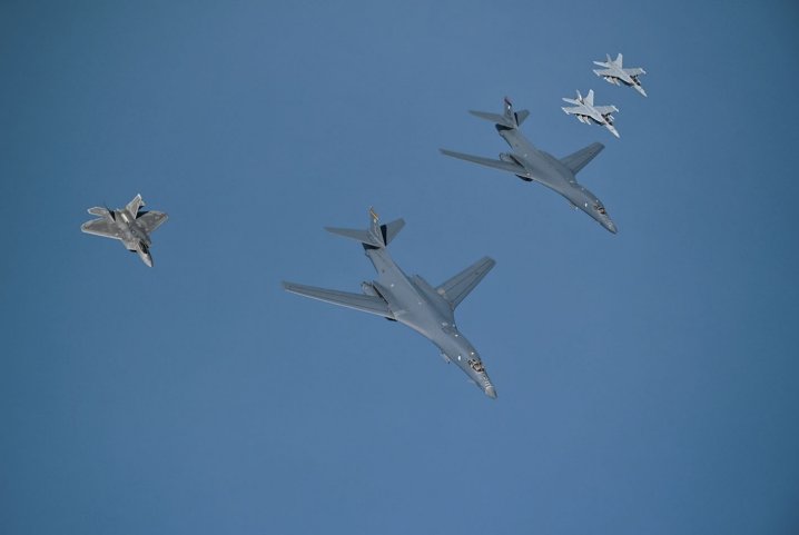 Two B-1B bombers are escorted over the Gulf by an F-22 Raptor and two EA-18G Growlers on their way to Prince Sultan Air Base in Saudi Arabia. (US Air Forces Central Command)