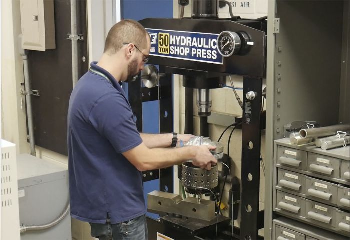 Reinhart completes final assembly of the Responsive Open Source Engine (ROSE) turbine in preparation for testing.  (Air Force Research Lab)