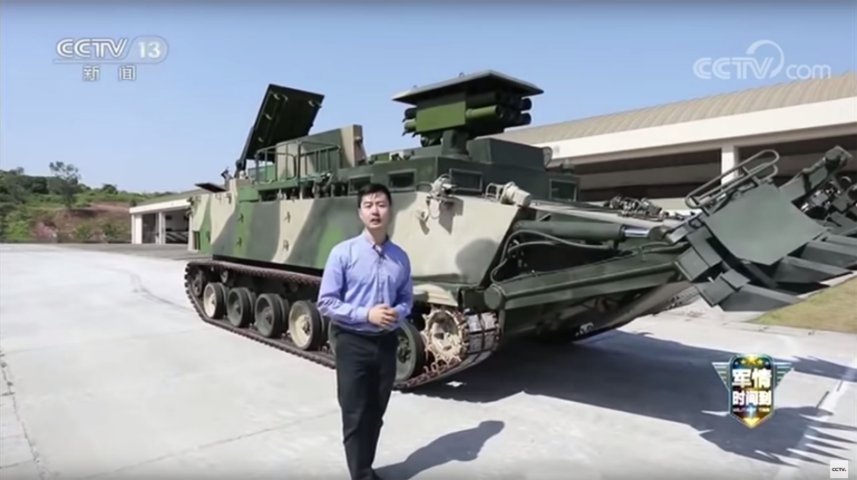 A still from a CCTV-13 video showing the PLANMC’s new armoured breaching vehicle (background). The platform carries an array of systems designed to ensure that a force can move through obstacles as quickly as possible. (CCTV-13)