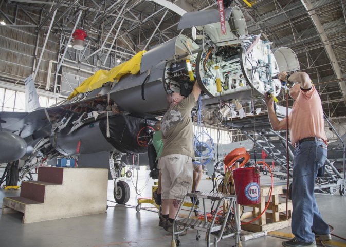 Maintenance personnel install mounting hardware for an APG-83 Scalable Agile Beam Radar on a 416th Flight Test Squadron F-16 Fighting Falcon during fitting trials. The USAF has now contracted Northrop Grumman to deliver 15 EMD and 90 production-standard radars for retrofit into the F-16. (US Air Force)