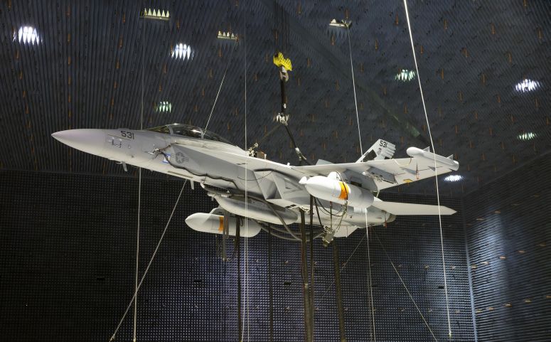 Two Next Generation Jammer Mid-Band (NGJ-MB) pods, attached to an EA-18G Growler, undergo testing in the Air Combat Environmental Test and Evaluation Facility anechoic chamber at Naval Air Station Patuxent River in Maryland. (US Navy)