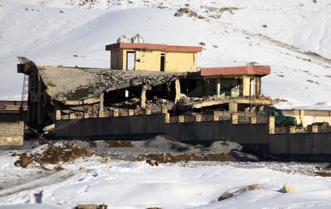 Afghan security officers secure the area of a collapsed building of the National Directorate of Security (NDS), following a Taliban attack, in Afghanistan’s Wardak province on 21 January 2019. (Getty Images)