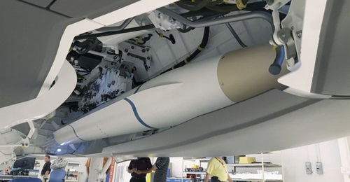 A model of the AARGM-ER missile being used for a fit check in an F-35 weapons bay.