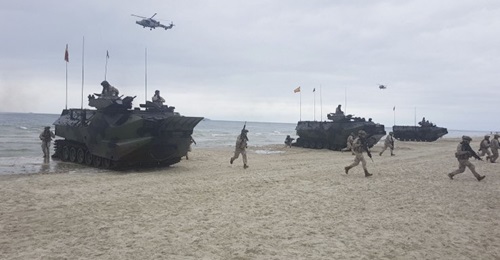 Spanish marines and armoured amphibious assault vehicles, deployed from the US Navy's Whidbey Island-class LSD amphibious assault ship USS Fort McHenry, come ashore on Palanga Beach, Lithuania, in an amphibious demonstration during 'BALTOPS 2019'. Due ...