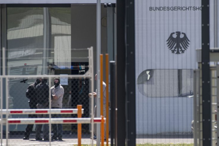 Masked policemen are seen on the grounds of the Federal Supreme Court (Bundesgerichtshof) in Karlsruhe, southern Germany, on 15 April after five Tajiks suspected to be members of an Islamic State terrorist cell were arrested. German police had arrested the Tajik nationals on suspicion of being members of an Islamic State terrorist cell planning attacks on US forces stationed in Germany, prosecutors said. Four of the suspects had been arrested after dawn raids targeting several apartments and six other locations in the western state of North Rhine-Westphalia. Another Tajik national had been detained previously.