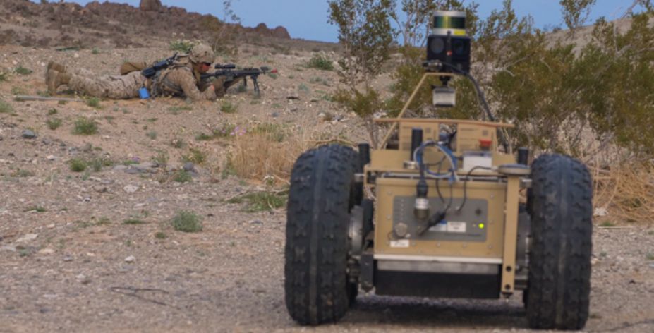 A US Marine Corps infantryman sets up a firing position while covered by an unmanned ground vehicle during field drills for DARPA’s Squad X programme, held at the Air Ground Combat Center in Twentynine Palms, California. (DARPA)