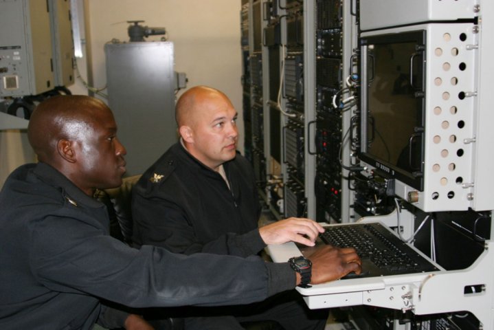 US Navy Cryptologic Technician (Collection) First Class Irving Juleus and Cryptologic Technician (Collection) First Class Terrance Krueger use a collections suite during a training operation on 6 April 2016 in San Diego, Calif. Navy leaders plan to transition all surface fleet vessels to the IaaS construct by 2023. (US Navy)