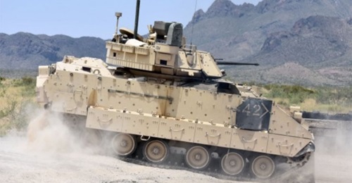 A M2A3 Bradley Fighting Vehicle crew changes position on the range during a gunnery training event in 2018. The US Army plans to issue a final RFP for its revamped Bradley replacement effort in December.
