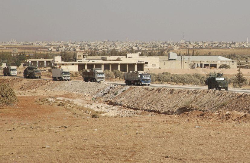 The convoy from the evacuated Turkish outpost east of Morek arrives in rebel-held territory near Al-Nayrab on 20 October. (Mohammed al-Rifai/AFP via Getty Images)