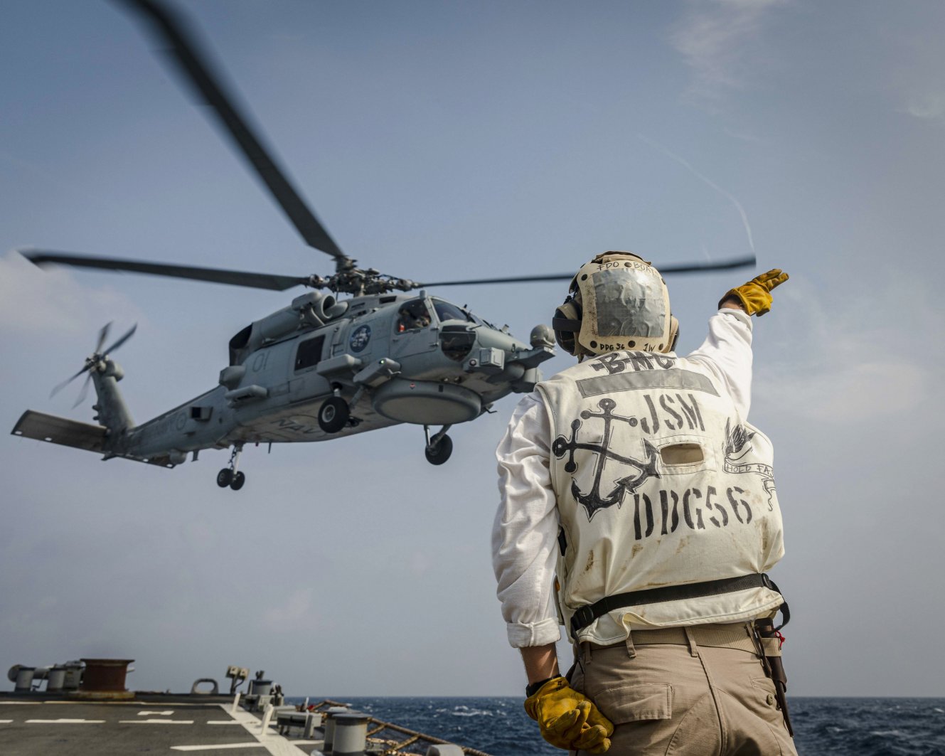 An MH-60R Sea Hawk helicopter from the Royal Australian Navy Anzac-class frigate HMAS Ballarat (FFH 155) takes off from the flight deck of the Arleigh Burke-class guided-missile destroyer USS John S. McCain (DDG 56) as part of ‘Malabar 2020’. (US Navy)