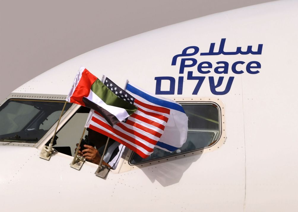 Emirati, Israeli, and US flags are attached to an El-Al aircraft with the word ‘peace’ written in Arabic, English, and Hebrew. The flight arrived at Abu Dhabi airport – the first commercial flight from Israel to the UAE – on 31 August 2020. (Karim Sahib/AFP via Getty Images)