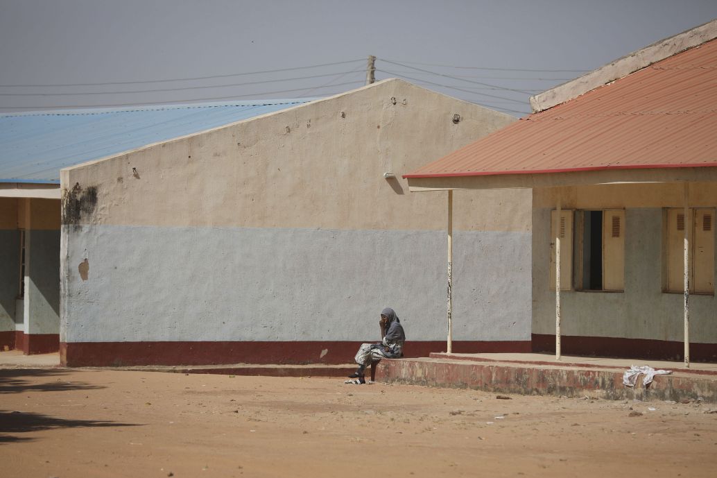 A parent sits outside the Government Science Secondary School in Kankara in Nigeria’s northwestern state of Katsina, where gunmen kidnapped more than 300 schoolboys on 11 December 2020. (Kola Sulaimon/contributor/AFP via Getty Images)