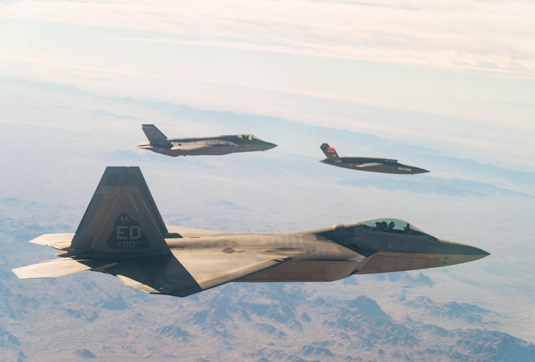 A US. Air Force F-22 Raptor and F-35A Lightning II fly in formation with the XQ-58A Valkyrie UAV over the U.S. Army Yuma Proving Ground testing range in Arizona, during a series of gatewayONE ‘fifth generation’ connectivity tests on 9 December.  (US Air Force)