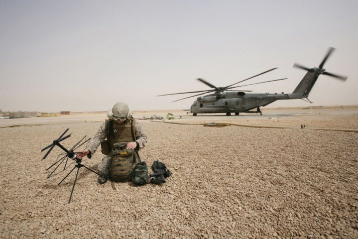 A US Marine Corps field radio operator from the 26th Marine Expeditionary Unit sets up satellite communication at Camp Korean Village, Iraq in 2008. (US Department of Defense )