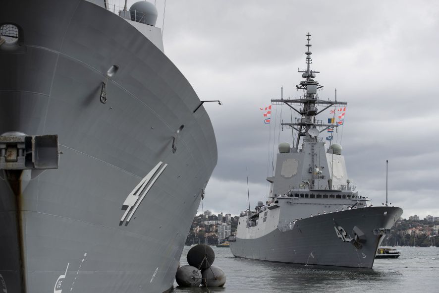 HMAS Sydney (right) departing Fleet Base East for its combat systems trials.  (Commonwealth of Australia)