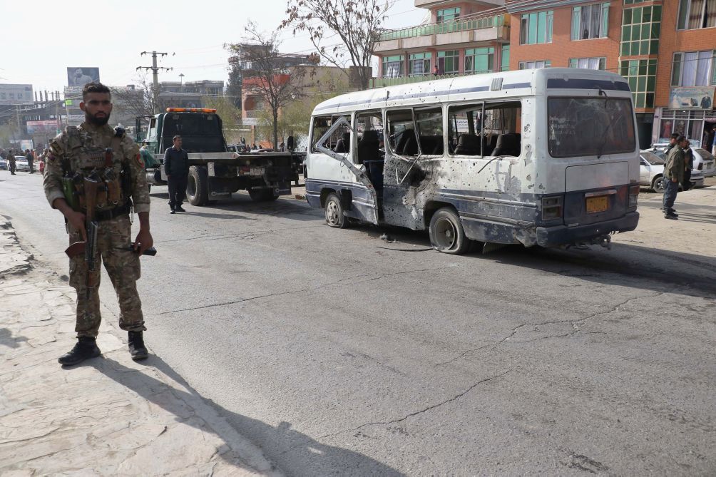 Afghan security officials inspect the scene of a roadside bomb attack that took place on 18 March in Kabul and targeted Afghan government employees. UNAMA said in a 14 April report that the number of civilian casualties in Afghanistan rose by 29% in the first three months of this year compared to the same period in 2020. (Haroon Sabawoon/Anadolu Agency via Getty Images)