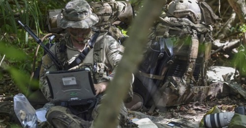 A US Air Force Special Operations weather technician sends intelligence to the National Reconnaissance Operations Center during the Marine's Reconnaissance Team Leader Course's final exercise on 31 Oct 2017.